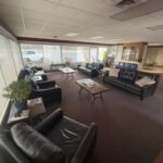 different angle of photo of main lobby showing leather couches and chairs
