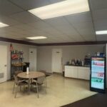 photo of corner of lobby with small table and chairs and snack food in the background
